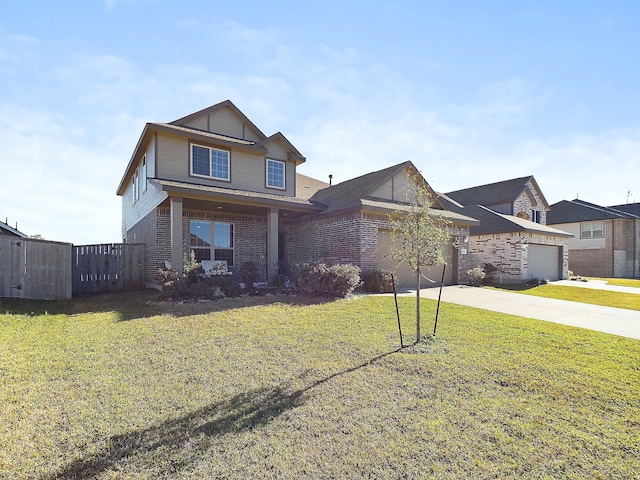 traditional-style house with driveway, an attached garage, fence, a front lawn, and brick siding