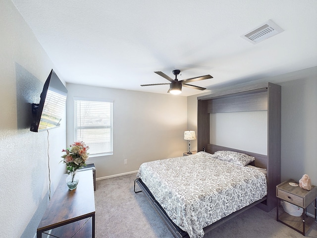 carpeted bedroom with visible vents, ceiling fan, and baseboards