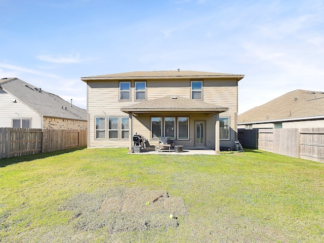 back of house featuring a yard, a fenced backyard, and a patio