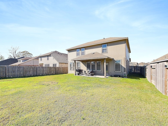 back of house with a patio area, a yard, and a fenced backyard