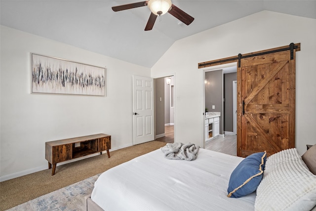 bedroom with a ceiling fan, lofted ceiling, baseboards, and a barn door