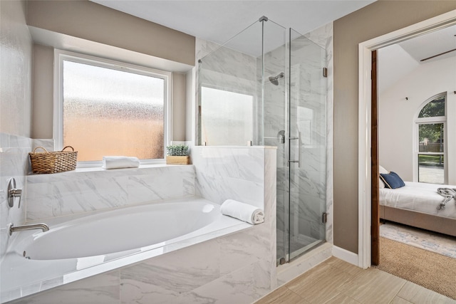 ensuite bathroom with ensuite bathroom, a marble finish shower, a garden tub, and a healthy amount of sunlight