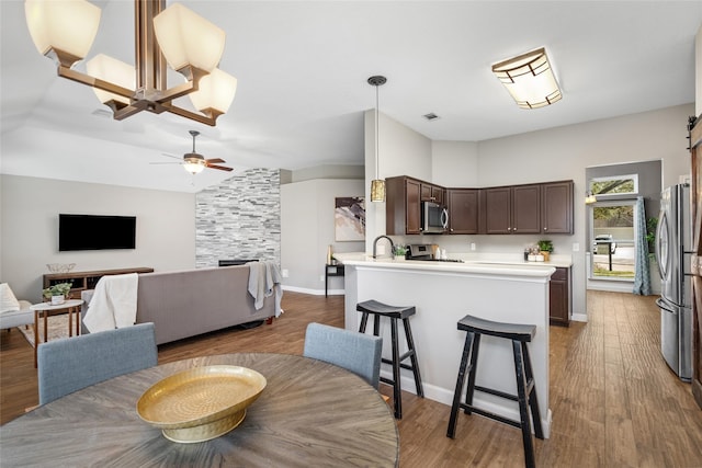 dining space with lofted ceiling, dark wood finished floors, visible vents, and baseboards