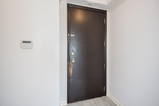 interior space with light tile patterned floors, visible vents, and baseboards