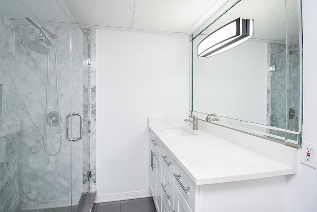 full bathroom featuring a marble finish shower, baseboards, and vanity