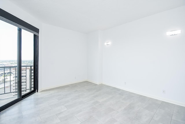 unfurnished room with baseboards