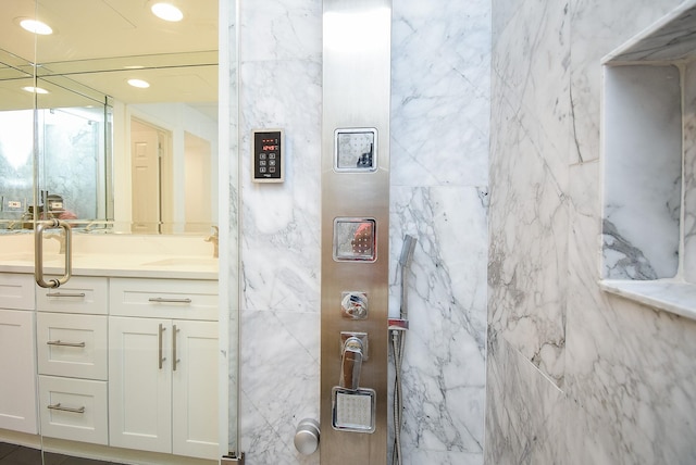 bathroom featuring recessed lighting, a sink, and double vanity