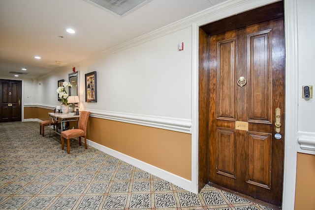 corridor with ornamental molding, recessed lighting, carpet flooring, and baseboards