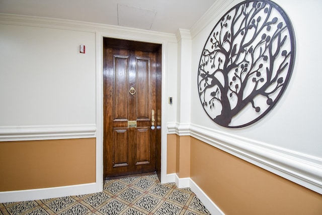 doorway to outside featuring baseboards, crown molding, and tile patterned floors