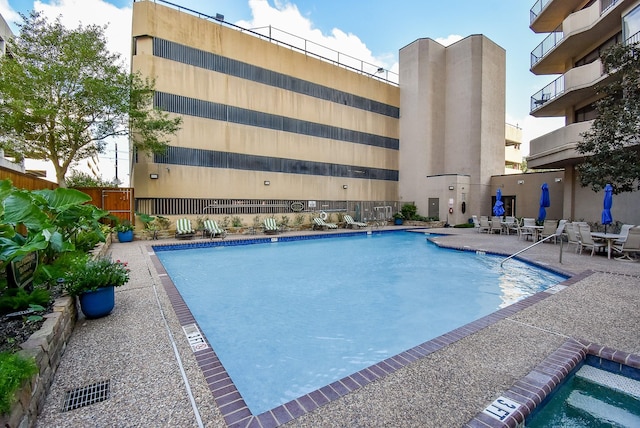 pool featuring fence and a patio