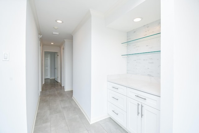 corridor featuring baseboards, ornamental molding, and recessed lighting