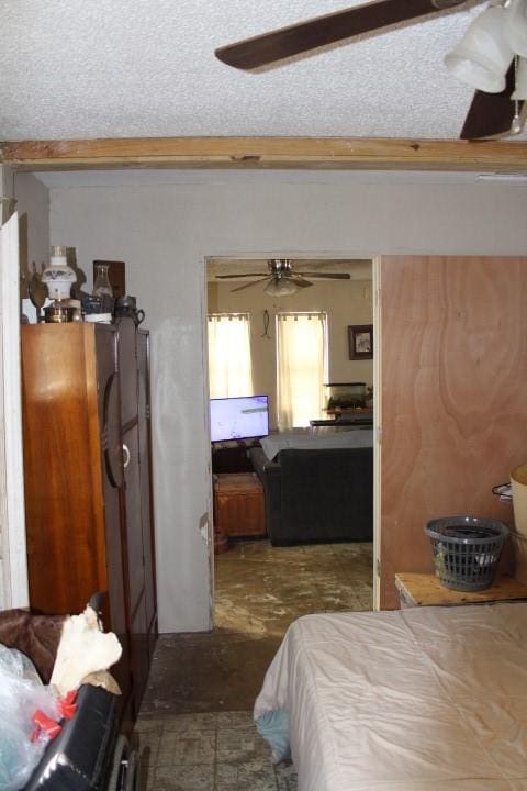 bedroom featuring a textured ceiling and ceiling fan