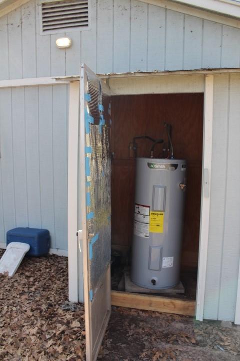 utility room with electric water heater