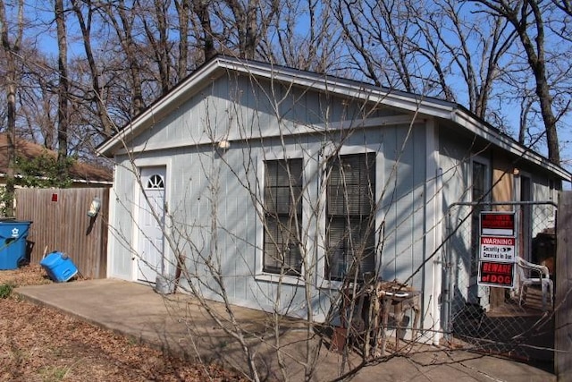 view of side of home featuring fence