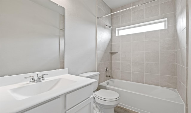 bathroom featuring toilet, vanity, and shower / tub combination