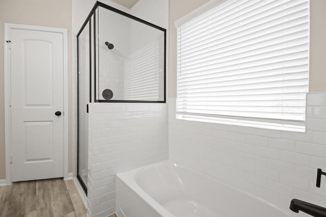 18798 Lucas Michael Way, New Caney, TX 77357 - full bath featuring a garden tub, a stall shower, and wood finished floors
