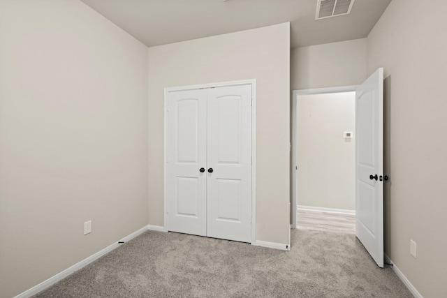 18798 Lucas Michael Way, New Caney, TX 77357 - unfurnished bedroom featuring light carpet, baseboards, and a closet