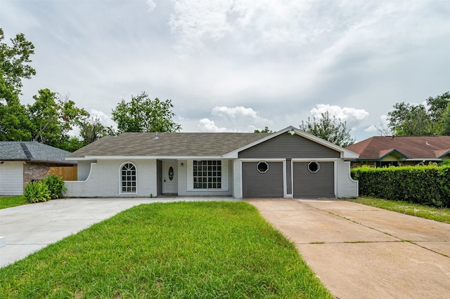 ranch-style home featuring concrete driveway, a front lawn, an attached garage, and brick siding