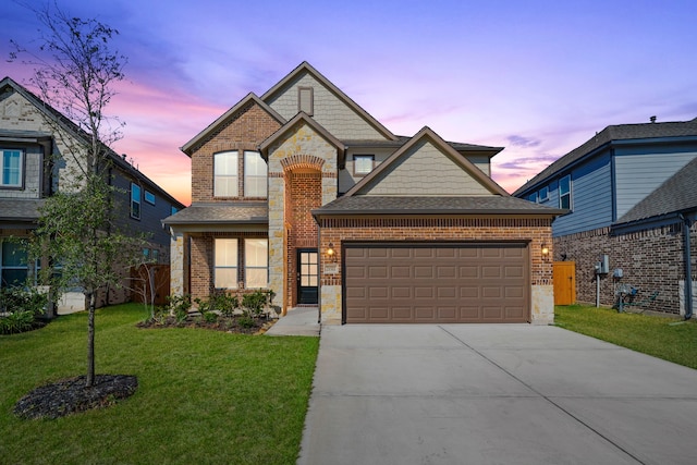 view of front facade featuring driveway, stone siding, an attached garage, a front lawn, and brick siding