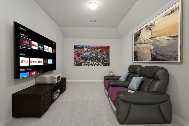 home theater room featuring baseboards, visible vents, vaulted ceiling, and carpet flooring