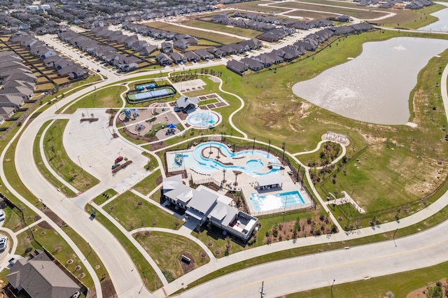 drone / aerial view with a water view and a residential view