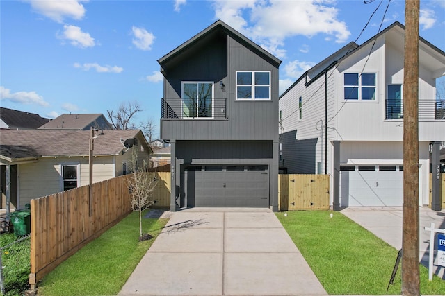 view of front of property featuring a balcony, a gate, fence, an attached garage, and concrete driveway