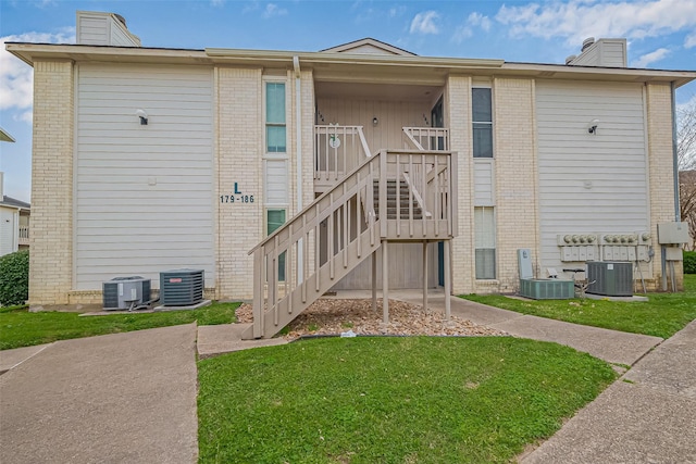 view of property featuring stairs and central air condition unit