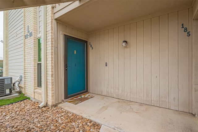 view of exterior entry with central air condition unit