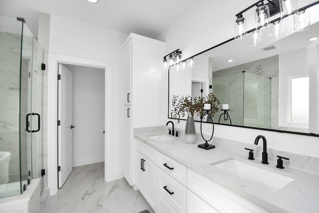 full bath with marble finish floor, a sink, a marble finish shower, and double vanity