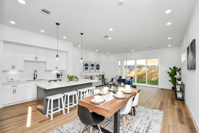 dining space with recessed lighting, visible vents, and light wood finished floors