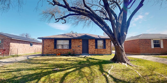 view of front facade featuring a front yard and brick siding