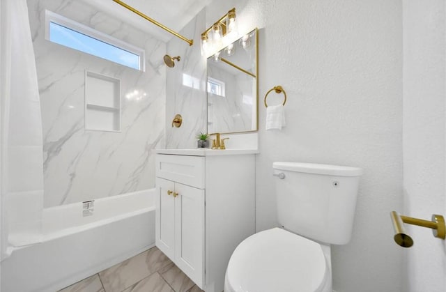 bathroom featuring marble finish floor, toilet, vanity, and shower / tub combination