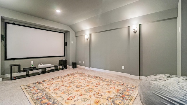 cinema with lofted ceiling, baseboards, and carpet flooring