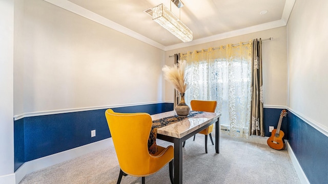 carpeted dining room with baseboards and ornamental molding