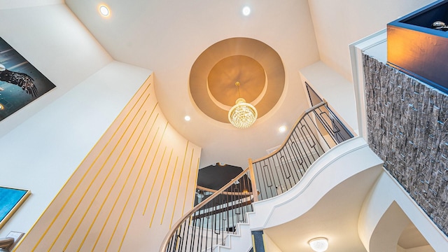 stairs with recessed lighting and a towering ceiling