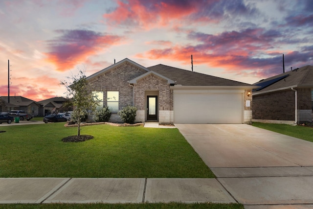 view of front facade featuring a garage, a shingled roof, brick siding, concrete driveway, and a front lawn