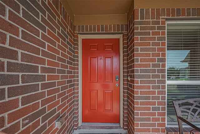 property entrance with brick siding