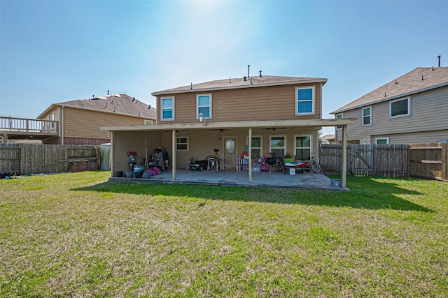 rear view of property with a patio area, a fenced backyard, and a yard