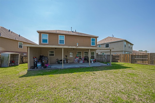 rear view of property featuring a patio area, a yard, and a fenced backyard