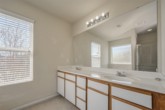 full bathroom featuring double vanity, baseboards, visible vents, and a sink