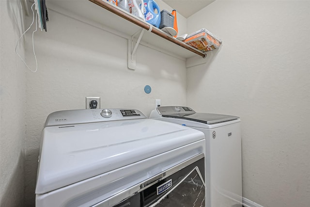 laundry room featuring washer and dryer and laundry area