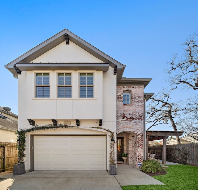 view of front facade featuring stucco siding, brick siding, driveway, and fence