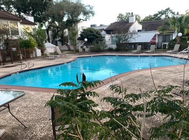 pool with fence and a patio