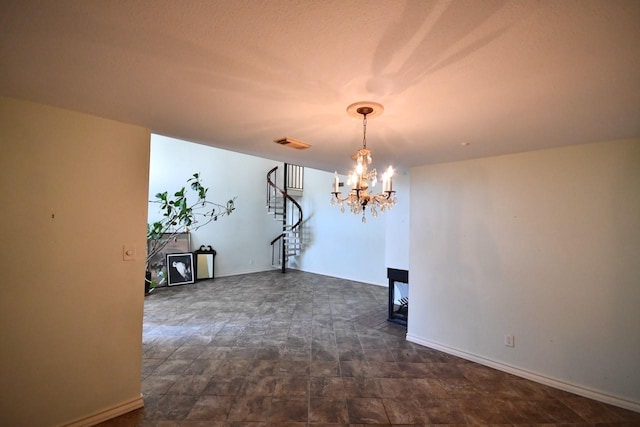 unfurnished dining area featuring visible vents, stairway, baseboards, and an inviting chandelier