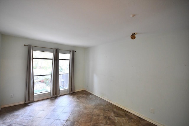 spare room featuring baseboards