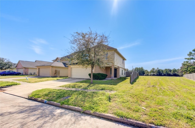 traditional home featuring a garage, concrete driveway, fence, and a front lawn