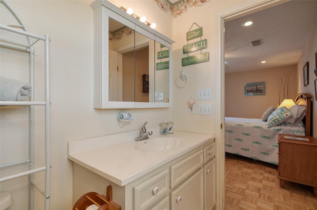 bathroom featuring recessed lighting, visible vents, connected bathroom, and vanity