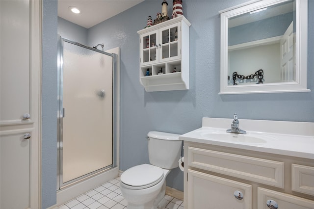 full bathroom with tile patterned flooring, toilet, a shower stall, and vanity