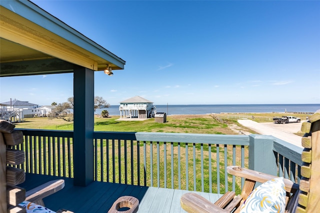 wooden deck featuring a yard and a water view