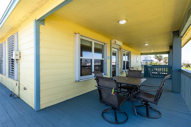 wooden deck featuring outdoor dining area